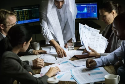 Accounting services in Sharjah – accountant analyzing financial statements and reports in a UAE office.